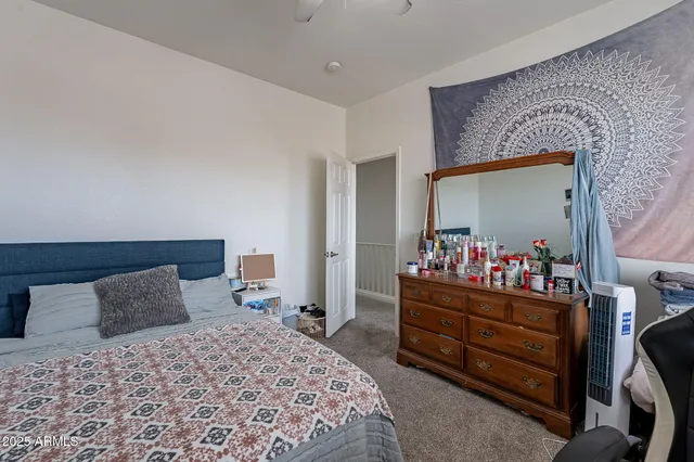 a bedroom with a bed and a dresser in it