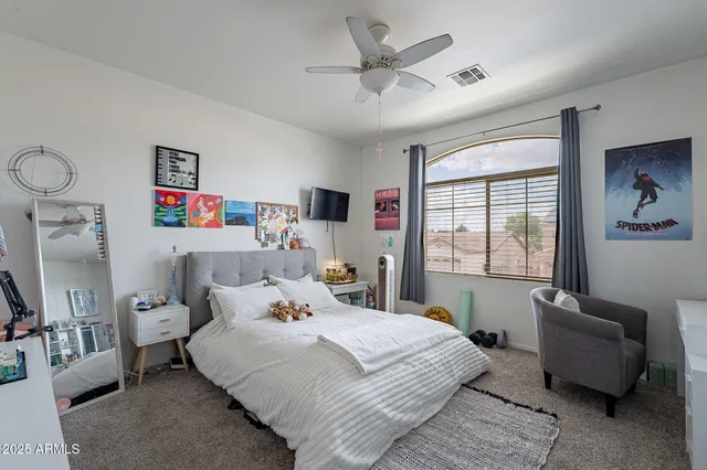 a bedroom with a bed couch and a window