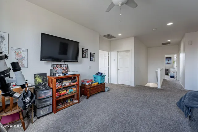 a view of a livingroom with workspace and a television