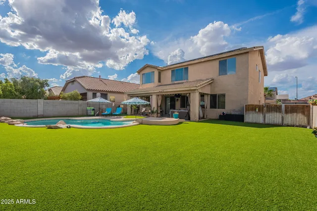 a view of house with swimming pool yard and outdoor seating