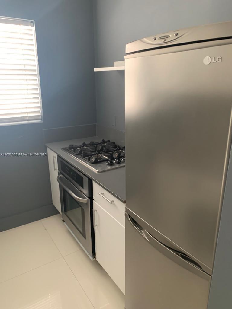 1604 Drexel Avenue, Unit 208 Miami Beach, FL 33139 - Photo 4 of 10 a storage room with washer and dryer