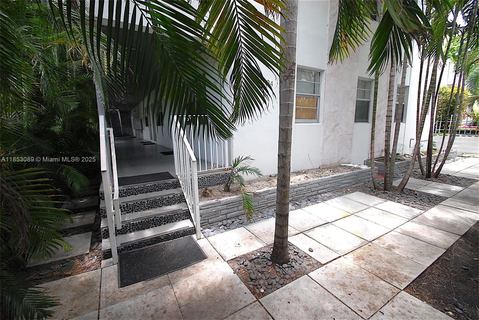 1604 Drexel Avenue, Unit 208 Miami Beach, FL 33139 - Photo 9 of 10 a view of a backyard with palm trees