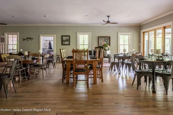 a dining room with furniture window and wooden floor