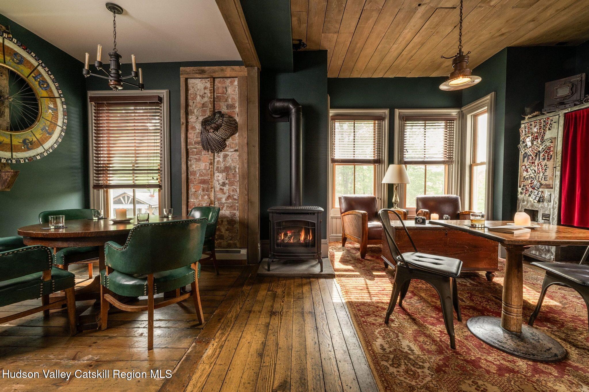 102 Main Street Jefferson, NY 12093 - Photo 23 of 57 a living room with furniture a dining table and a fireplace