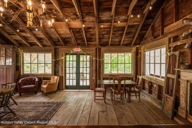 a bedroom with a bed a table and chair