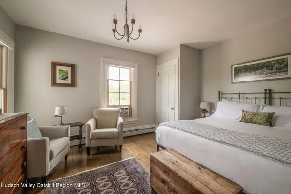 a bedroom with a bed and a chandelier
