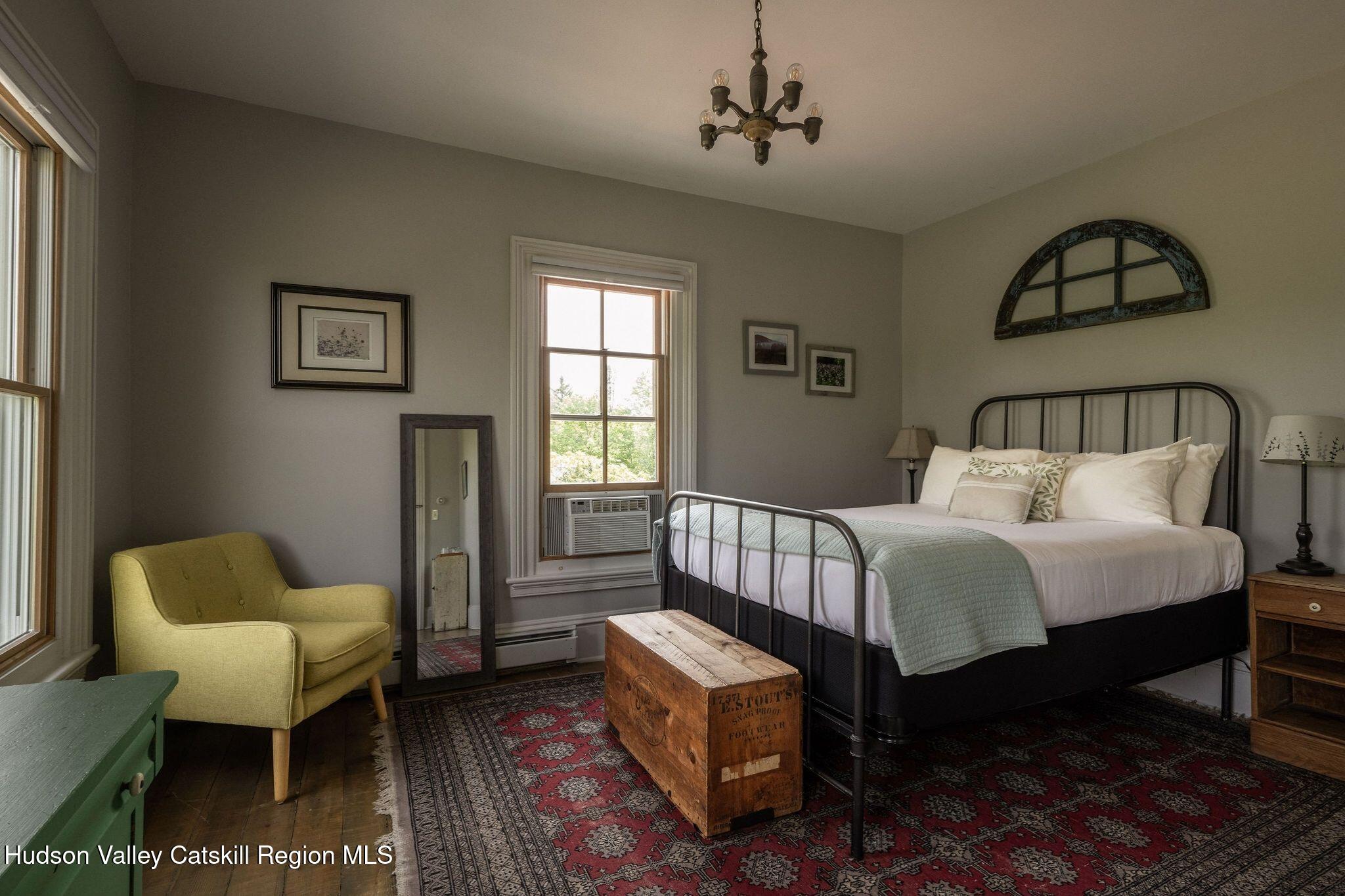 102 Main Street Jefferson, NY 12093 - Photo 50 of 57 a bedroom with a bed and a chandelier