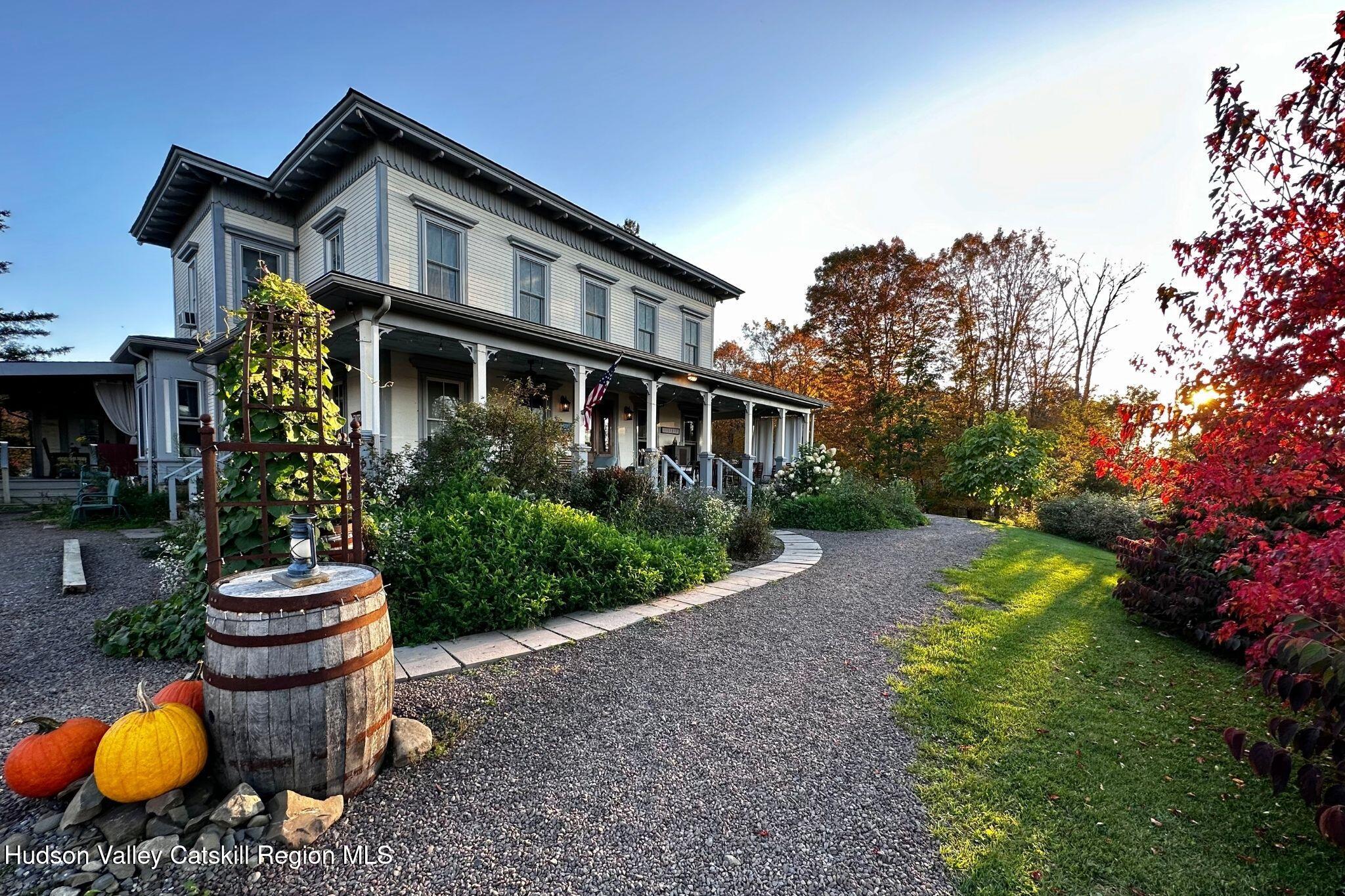 102 Main Street Jefferson, NY 12093 - Photo 10 of 57 a front view of a house with a yard and potted plants