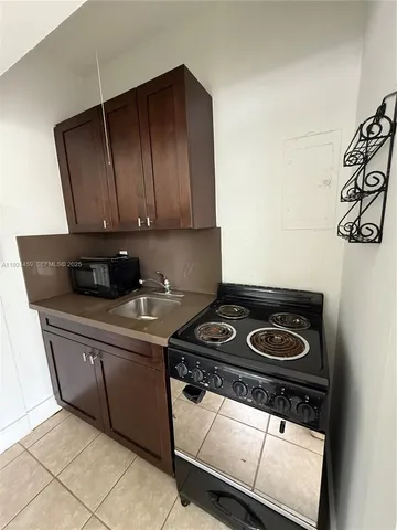 a kitchen with a stove and a microwave