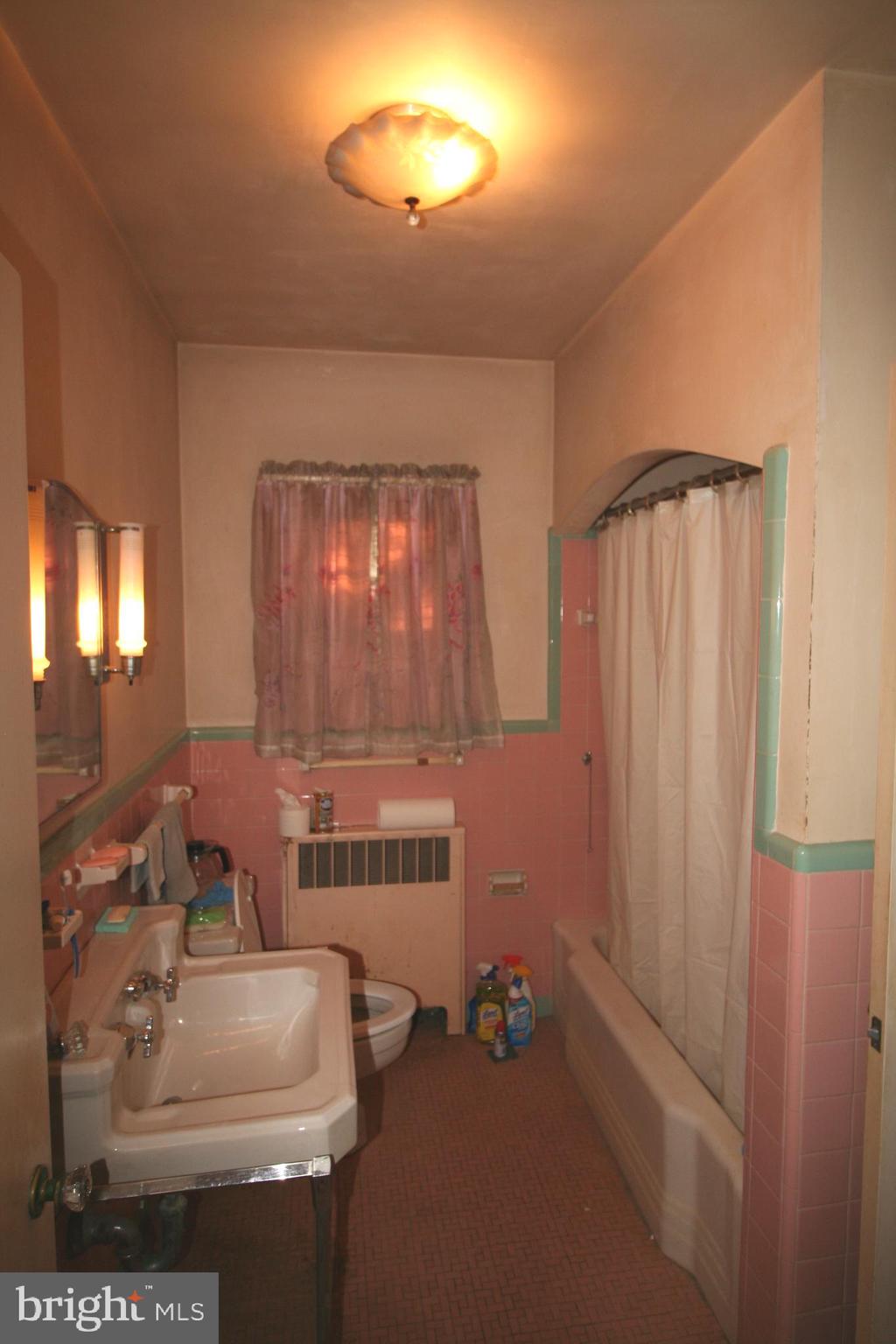 6510 16th Street Northwest Washington, DC 20012 - Photo 18 of 32 a bathroom with a sink a toilet and mirror