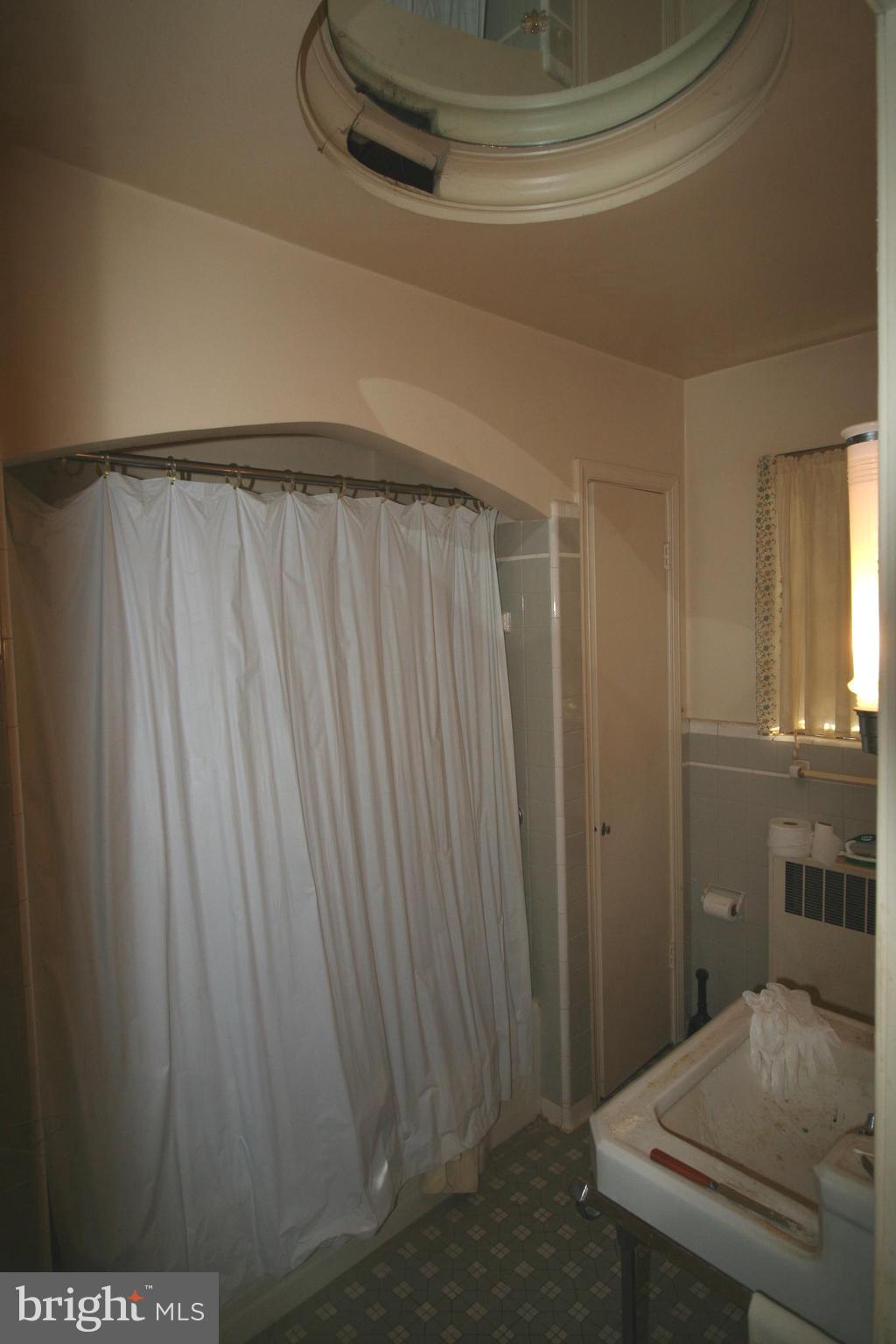 6510 16th Street Northwest Washington, DC 20012 - Photo 19 of 32 a bathroom with a sink and a mirror
