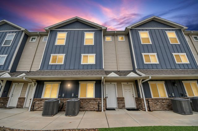 a front view of a residential apartment building with a yard