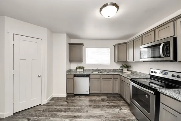 a kitchen with a sink stove and microwave