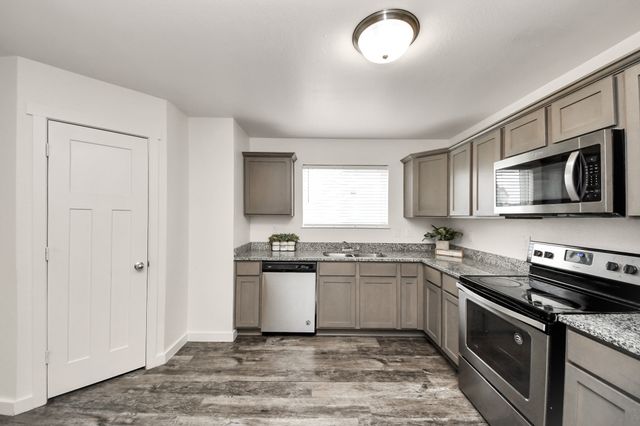a kitchen with a sink stove and microwave