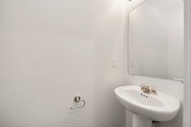 a bathroom with a sink and mirror