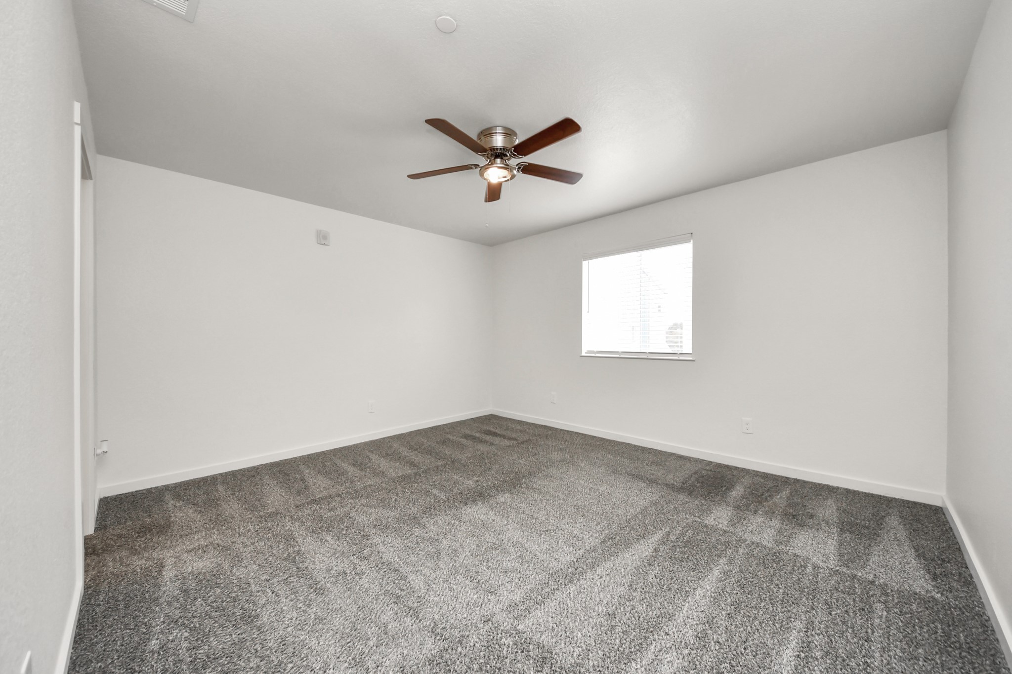 21155 Gosling Road, Unit 40 Spring, TX 77388 - Photo 15 of 33 an empty room with windows and fan