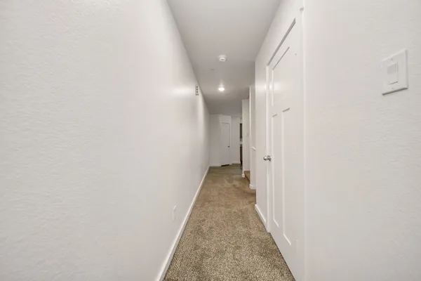 a view of a hallway with a white door