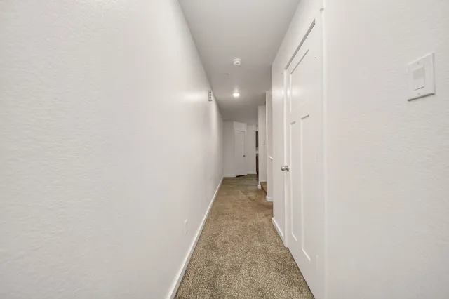 a view of a hallway with a white door