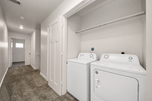 a view of storage and utility room with washer and dryer