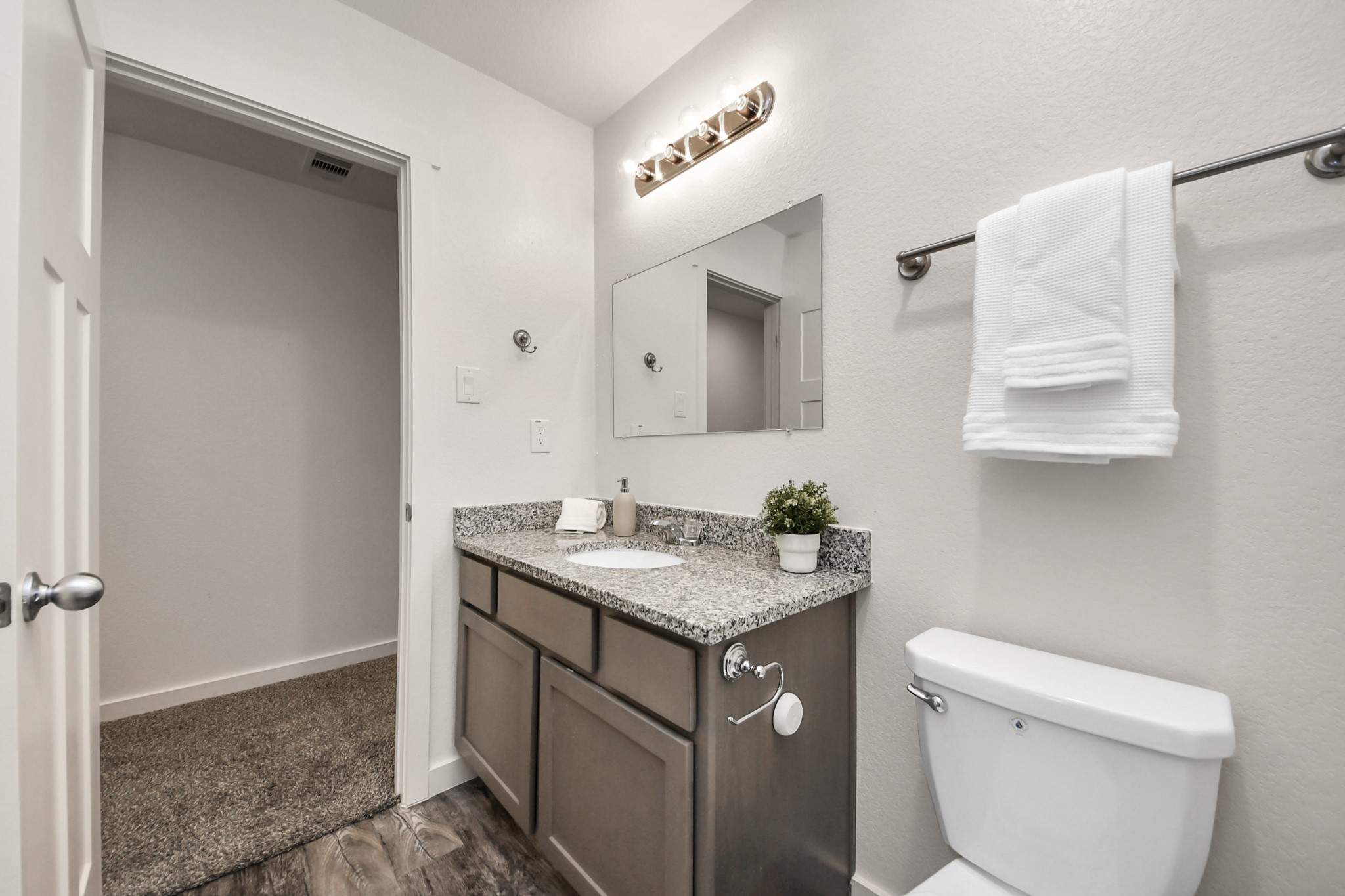 21155 Gosling Road, Unit 40 Spring, TX 77388 - Photo 30 of 33 a bathroom with a granite countertop sink a toilet and a mirror