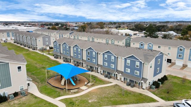 an aerial view of a house with a big yard