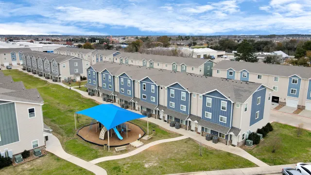 an aerial view of a house with a big yard