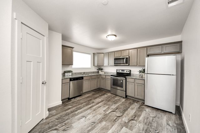 a kitchen with a refrigerator stove and microwave