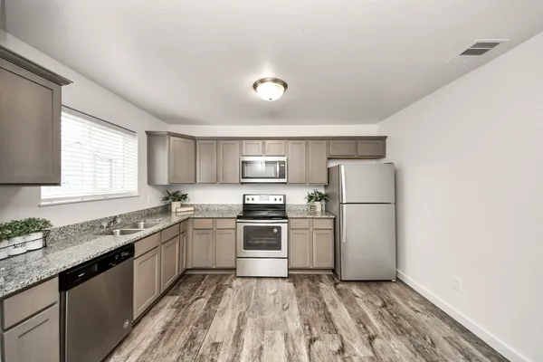 a kitchen with a sink a stove and refrigerator