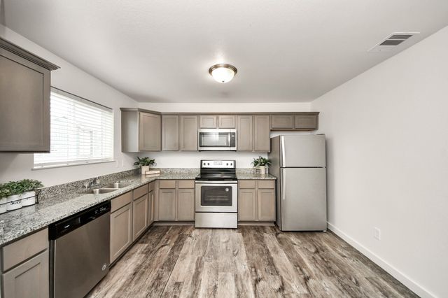 a kitchen with a sink a stove and refrigerator