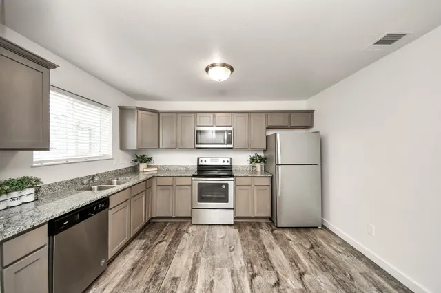 a kitchen with a sink a stove and refrigerator