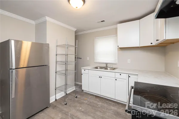a kitchen with stainless steel appliances a refrigerator sink and cabinets