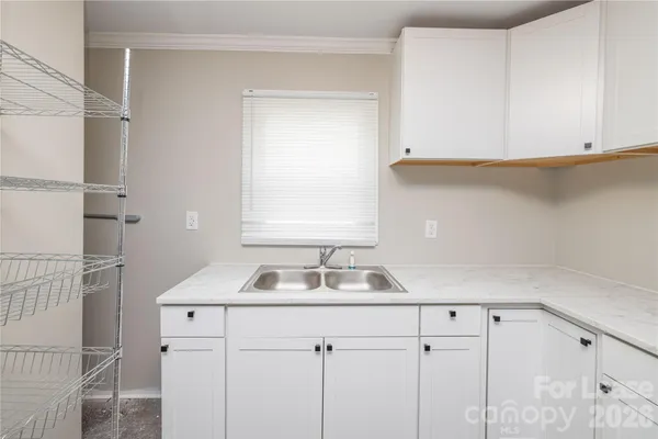 a kitchen with a sink and cabinets