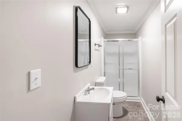 a bathroom with a sink mirror vanity and toilet