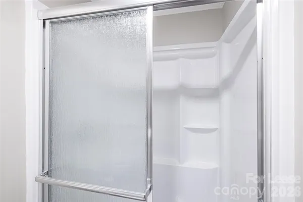 a bathroom with a glass shower door