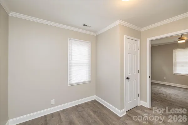 an empty room with windows and closet