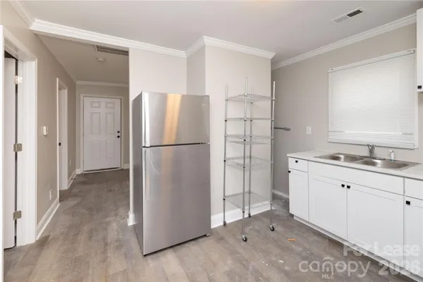 a kitchen with a refrigerator and a sink