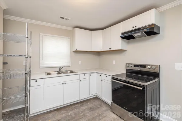 a kitchen with appliances cabinets and a sink
