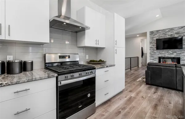 a kitchen with stainless steel appliances granite countertop a stove and a granite counter tops