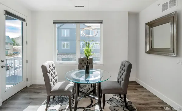 a dining room with furniture and window