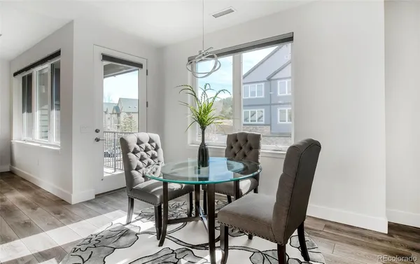 a view of a dining room with furniture window and wooden floor