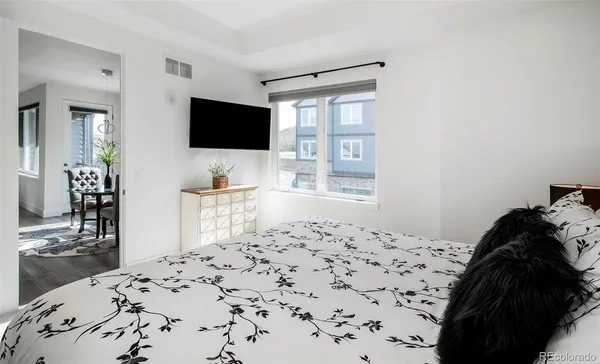 a bedroom with a bed and flat screen tv