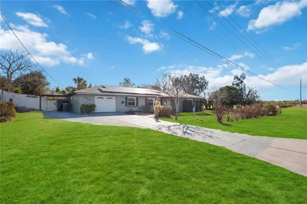 a front view of house with yard and green space