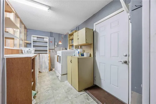 a utility room with cabinets washer and dryer