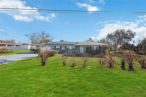 a view of a house with a backyard