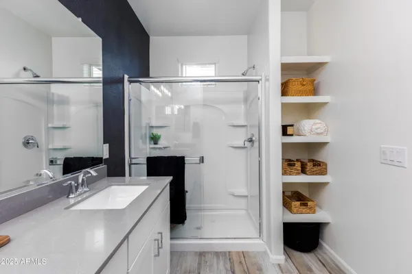 a bathroom with a sink a toilet and shower