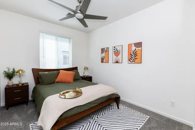 a bedroom with a bed and a ceiling fan