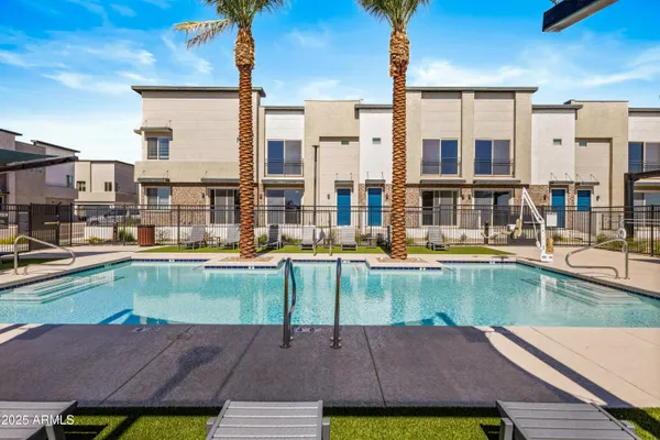 a view of a swimming pool with a lounge chairs