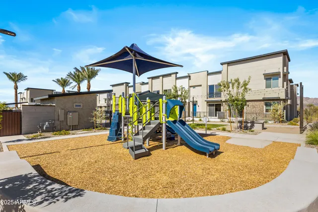a view of a lake with a building and trees in the background