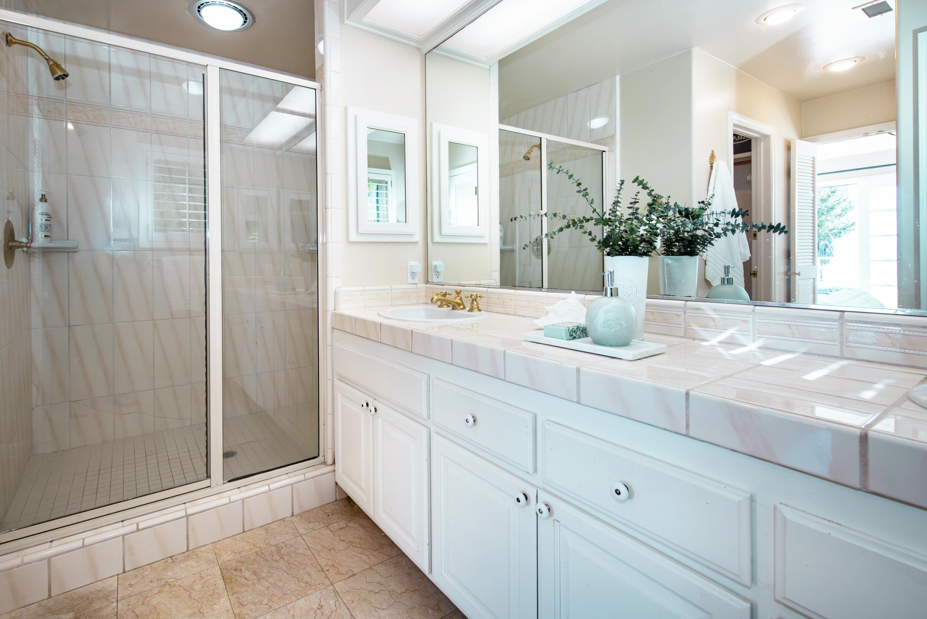 2525 Emerson Street Summerland, CA 93067 - Photo 13 of 26 a bathroom with a granite countertop sink a mirror and shower