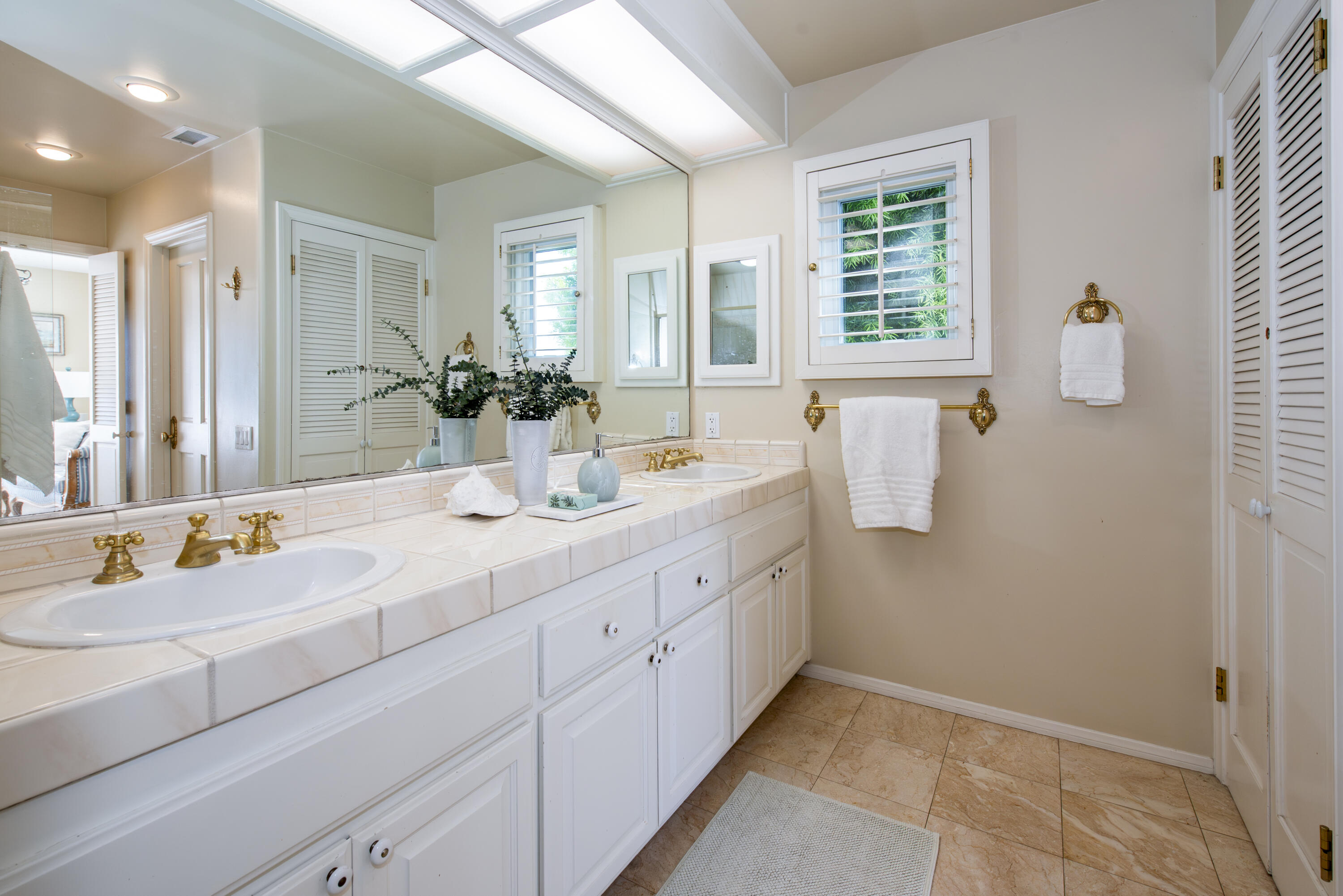 2525 Emerson Street Summerland, CA 93067 - Photo 14 of 26 a bathroom with a double vanity sink a mirror and a shower